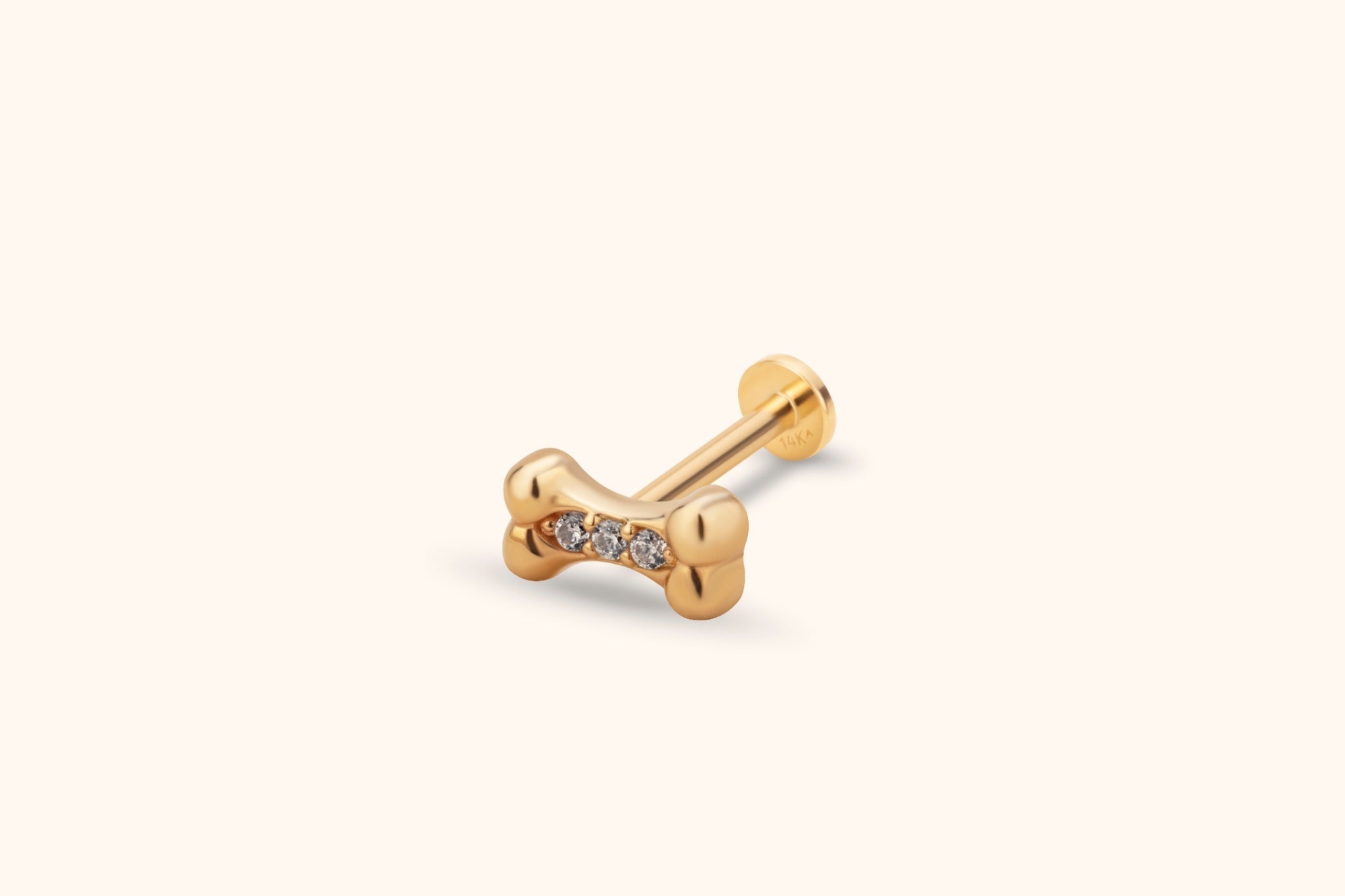 14K Guld Piercing Med Hundbenmotiv Och Tre Gnistrande Stenar - Noxlookjewelry